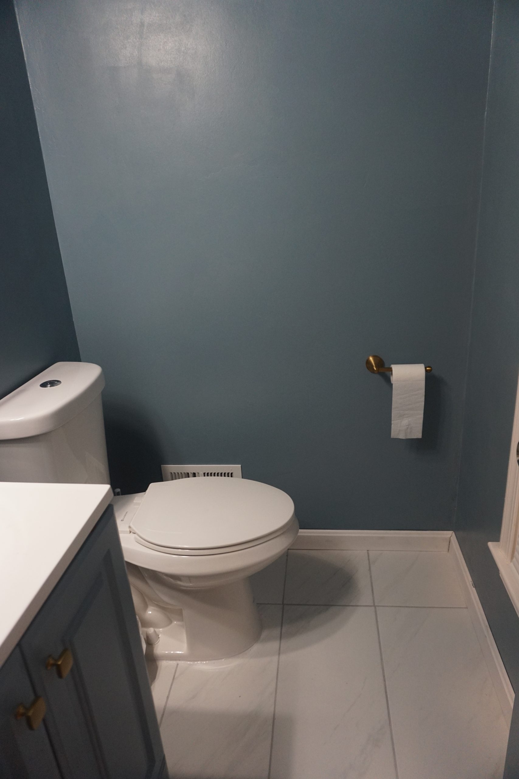 Picture of our half bathroom after it had been tiled and painted with Good Jeans by Clare Paint. Clare Paint in this bathroom looks like a deep blue gray